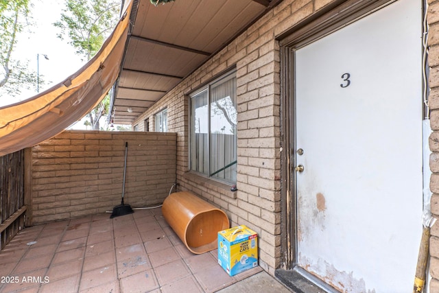 doorway to property featuring brick siding