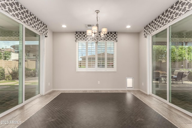 unfurnished dining area with visible vents, wood finished floors, baseboards, a chandelier, and recessed lighting