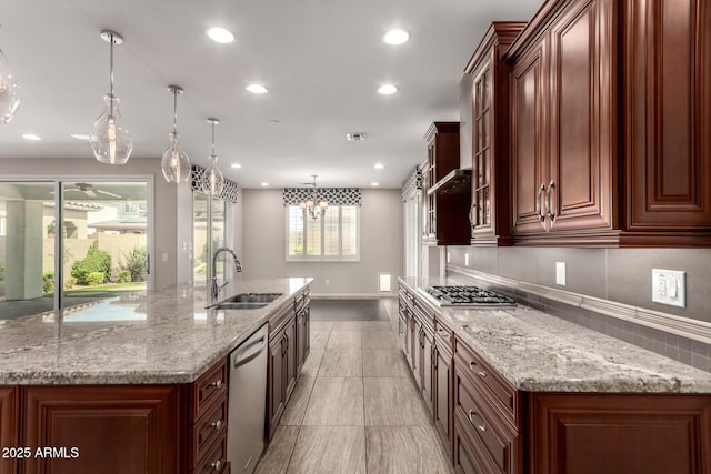 kitchen with a sink, appliances with stainless steel finishes, a large island with sink, and recessed lighting