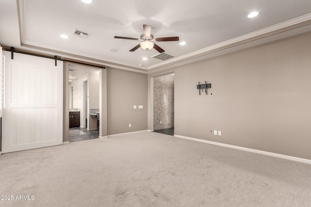 unfurnished bedroom featuring carpet, recessed lighting, a barn door, and visible vents
