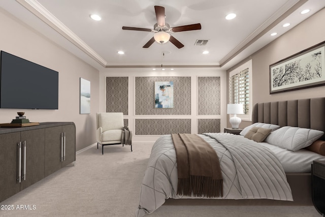 bedroom with visible vents, recessed lighting, a tray ceiling, and light carpet