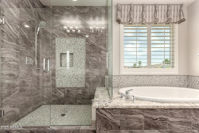 bathroom with a shower stall, a healthy amount of sunlight, and a bath