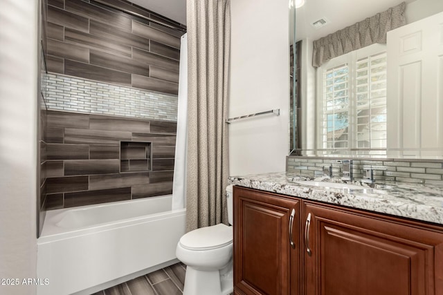 bathroom featuring toilet, visible vents, shower / bath combination with curtain, and vanity