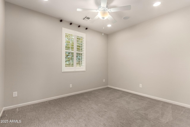 empty room featuring carpet flooring, recessed lighting, baseboards, and visible vents