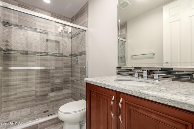 bathroom with visible vents, vanity, toilet, recessed lighting, and a stall shower
