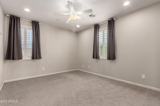carpeted spare room with baseboards, a ceiling fan, recessed lighting, and visible vents