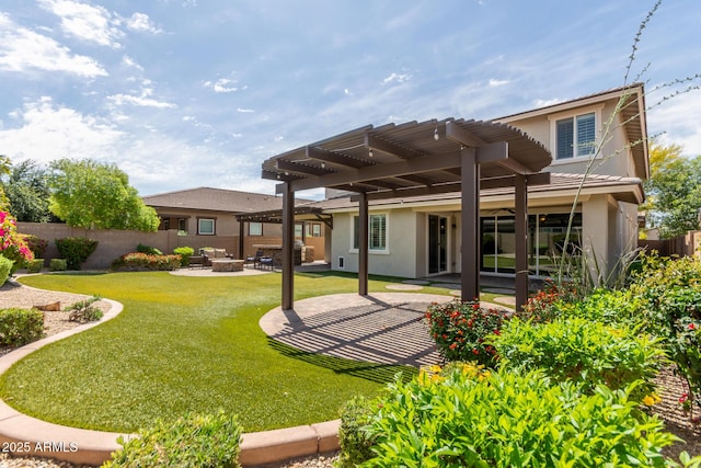 rear view of house featuring a patio, fence, a yard, a pergola, and stucco siding