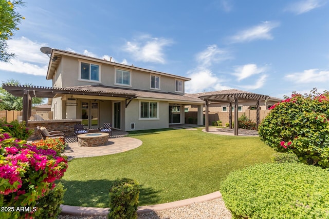 back of house featuring a patio area, a yard, a pergola, a fire pit, and stucco siding