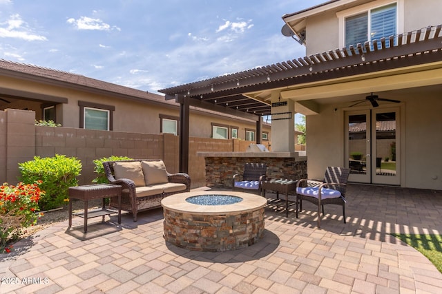 view of patio with ceiling fan, fence, french doors, and an outdoor living space with a fire pit