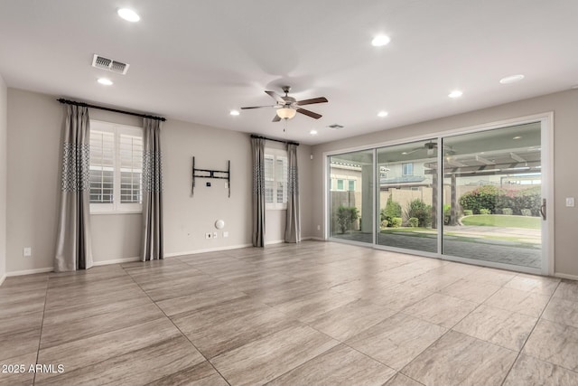 spare room featuring recessed lighting, ceiling fan, visible vents, and a healthy amount of sunlight