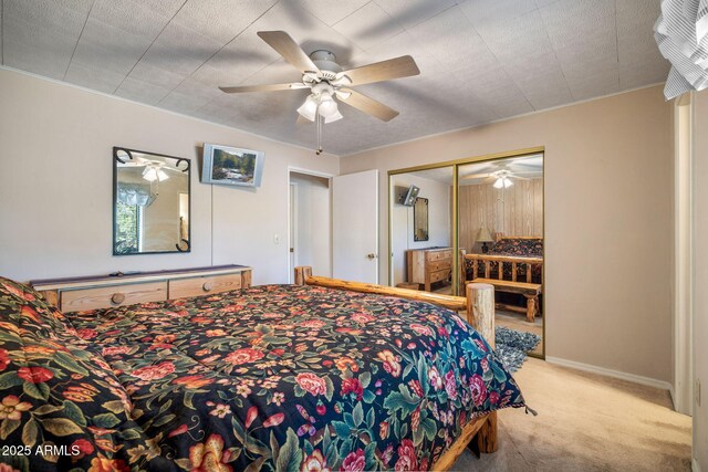 bedroom featuring a closet, baseboards, a ceiling fan, and carpet flooring