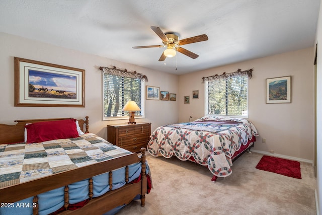 carpeted bedroom featuring baseboards and ceiling fan