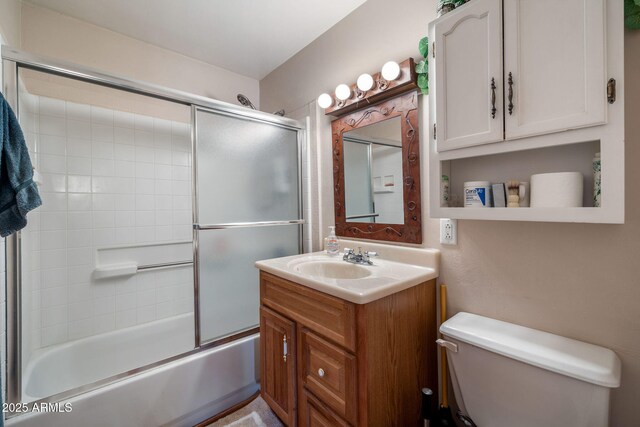 full bathroom featuring vanity, toilet, and combined bath / shower with glass door