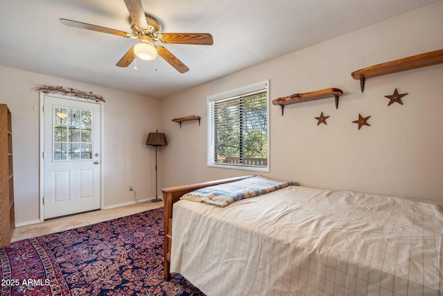 bedroom with multiple windows, carpet flooring, a ceiling fan, and baseboards