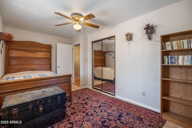 bedroom with a closet, baseboards, and ceiling fan