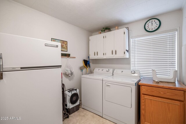 washroom featuring cabinet space and washer and dryer