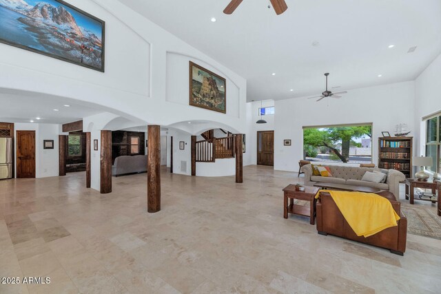 3611 E Ahwatukee Dr, Phoenix, AZ 85044 - living room featuring a ceiling fan, a towering ceiling, stairs, ornate columns, and recessed lighting