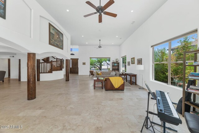 3611 E Ahwatukee Dr, Phoenix, AZ 85044 - living room featuring a high ceiling, a ceiling fan, stairway, arched walkways, and recessed lighting