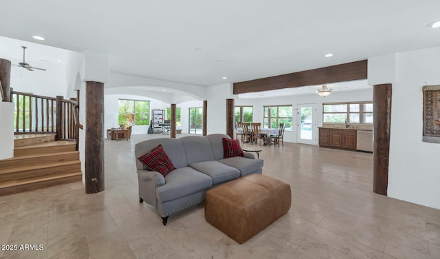 3611 E Ahwatukee Dr, Phoenix, AZ 85044 - living area with arched walkways, recessed lighting, ceiling fan, stairway, and decorative columns