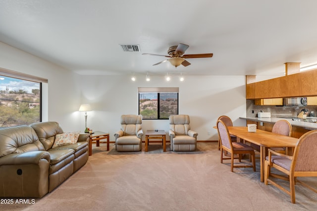 272 N Cucuracha St, Wickenburg, AZ 85390 - living room with track lighting, a ceiling fan, light carpet, and baseboards