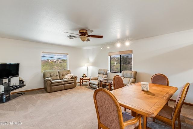 272 N Cucuracha St, Wickenburg, AZ 85390 - dining area with ceiling fan, rail lighting, healthy amount of natural light, and light colored carpet