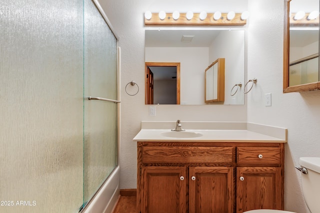 272 N Cucuracha St, Wickenburg, AZ 85390 - full bathroom with toilet, combined bath / shower with glass door, and vanity