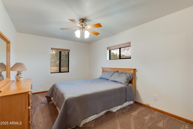 272 N Cucuracha St, Wickenburg, AZ 85390 - carpeted bedroom featuring baseboards, multiple windows, and a ceiling fan