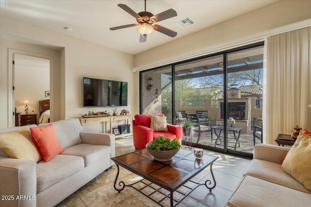 tiled living area featuring visible vents and a ceiling fan