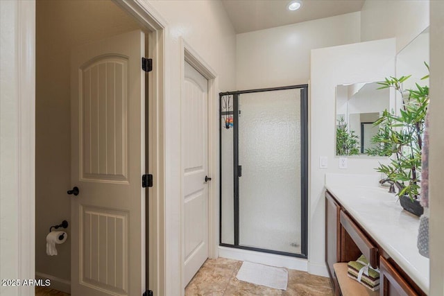 full bathroom with a shower stall and vanity