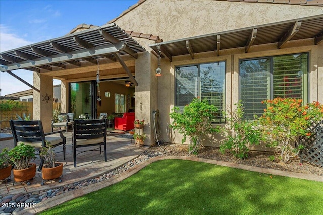 view of patio with ceiling fan and a pergola