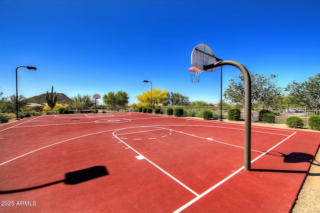 view of sport court featuring community basketball court and fence