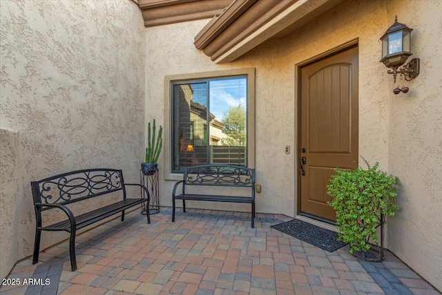 view of exterior entry with stucco siding