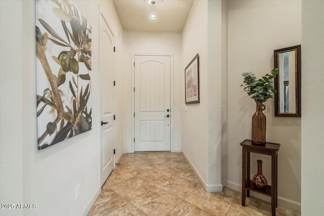 doorway to outside with baseboards