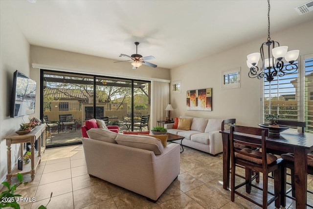 living room with ceiling fan with notable chandelier, tile patterned flooring, and visible vents