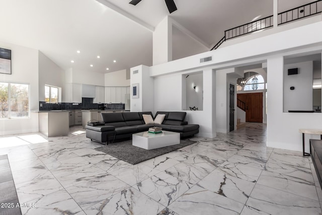 living room with sink, high vaulted ceiling, and ceiling fan