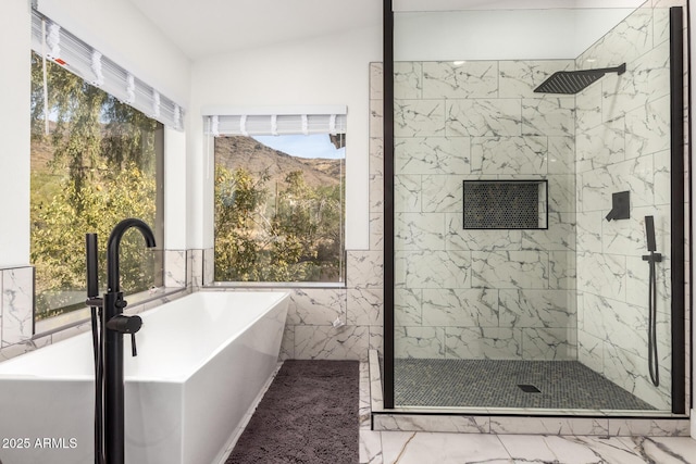 bathroom with sink, independent shower and bath, and vaulted ceiling