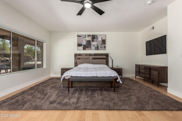 bedroom with hardwood / wood-style flooring and ceiling fan