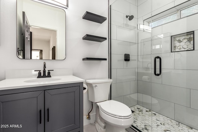 bathroom with vanity, toilet, and a shower with shower door