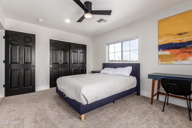 carpeted bedroom featuring ceiling fan and a closet