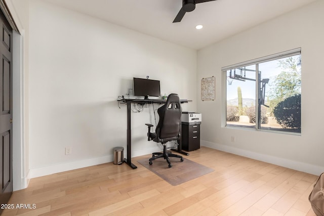 office area with light hardwood / wood-style floors and ceiling fan