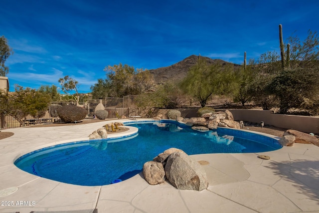 view of pool with a patio and a mountain view