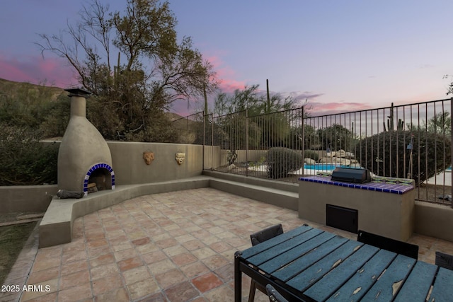 view of patio terrace at dusk