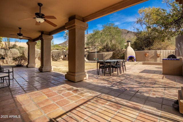 view of patio / terrace with a mountain view and ceiling fan