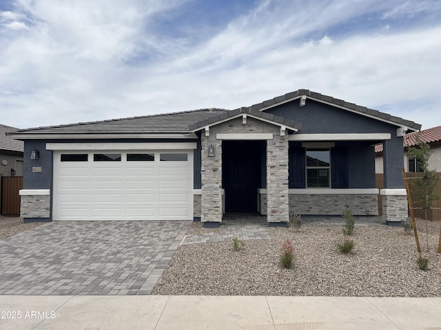 40512 W Rio Grande Dr, Maricopa, AZ 85138 - view of front of property with stone siding, decorative driveway, an attached garage, stucco siding, and a tiled roof