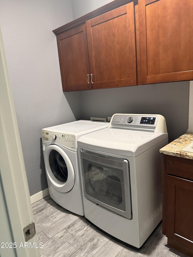 10236 W Wood St, Tolleson, AZ 85353 - laundry room featuring cabinet space, separate washer and dryer, and baseboards