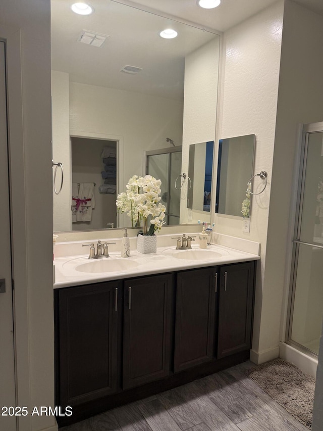 10236 W Wood St, Tolleson, AZ 85353 - bathroom with a shower stall, double vanity, and wood finished floors