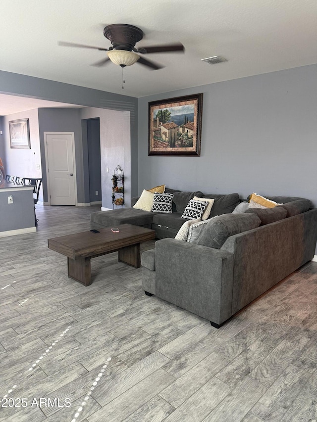 10236 W Wood St, Tolleson, AZ 85353 - living room with a ceiling fan, wood finished floors, and baseboards