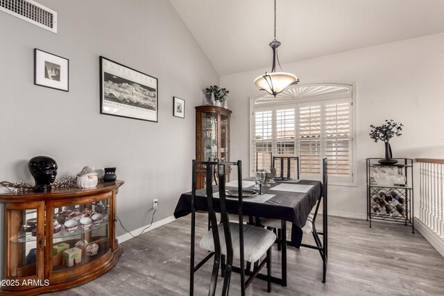 7460 E Kiowa Ave, Mesa, AZ 85209 - dining room featuring wood finished floors, baseboards, and high vaulted ceiling