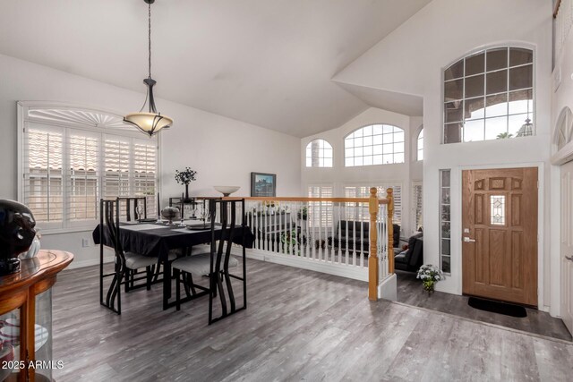 7460 E Kiowa Ave, Mesa, AZ 85209 - dining space featuring wood finished floors, high vaulted ceiling, and baseboards