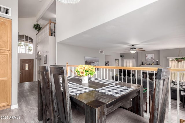 7460 E Kiowa Ave, Mesa, AZ 85209 - dining area featuring wood finished floors, ceiling fan, high vaulted ceiling, and beamed ceiling